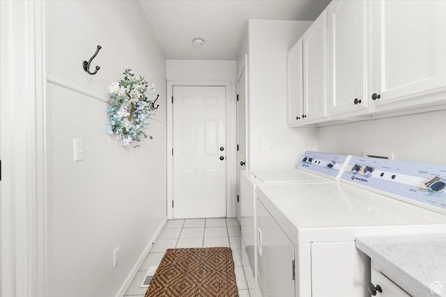 laundry room with baseboards, cabinet space, independent washer and dryer, and light tile patterned floors