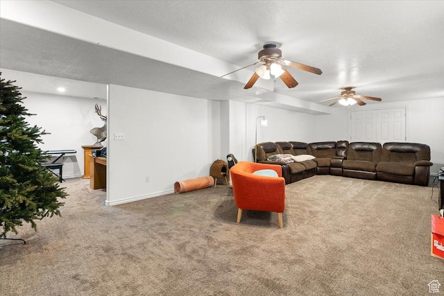 living room with carpet floors, a textured ceiling, baseboards, and ceiling fan