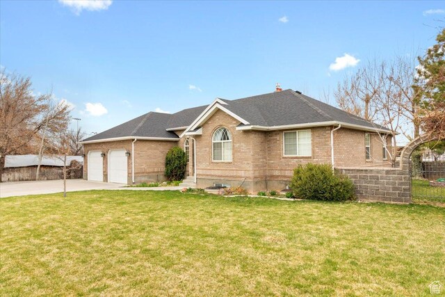 view of front of house with fence, a garage, concrete driveway, a front yard, and brick siding