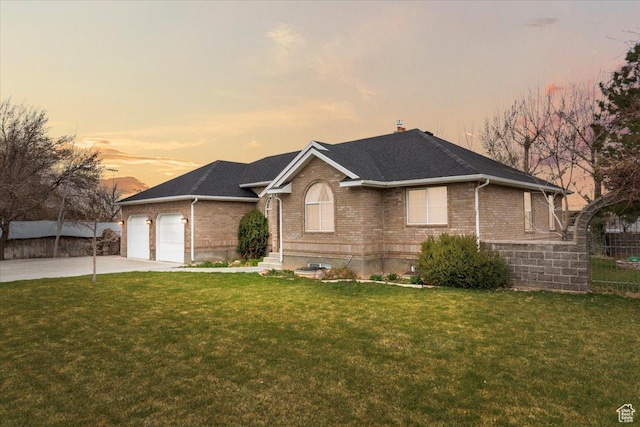 ranch-style home with brick siding, concrete driveway, a garage, and a front lawn