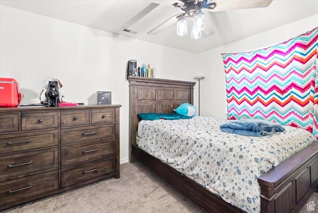 bedroom with visible vents, a ceiling fan, and light colored carpet
