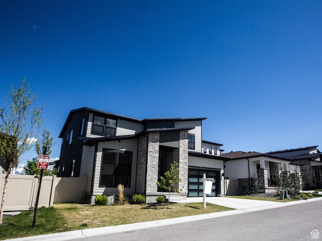 14913 S Thorntree Ln, Herriman, UT 84096 - view of front facade with stone siding, a garage, and concrete driveway