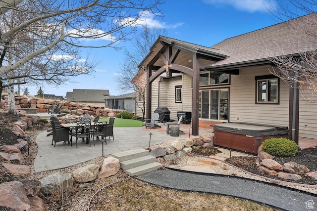 1049 S Meadow Lark Ln E, Huntsville, UT 84317 - back of property featuring a hot tub, a patio area, a shingled roof, and outdoor dining space