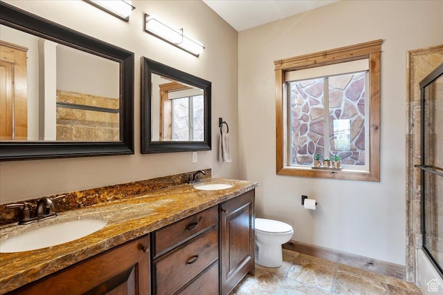 1049 S Meadow Lark Ln E, Huntsville, UT 84317 - bathroom featuring toilet, double vanity, baseboards, and a shower with door