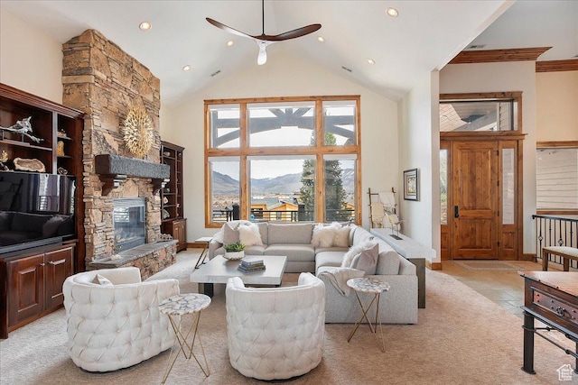 1049 S Meadow Lark Ln E, Huntsville, UT 84317 - living area with high vaulted ceiling, a mountain view, a ceiling fan, a stone fireplace, and light carpet