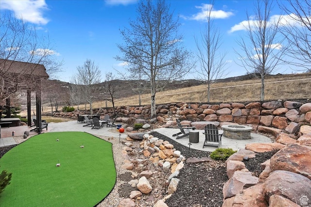 1049 S Meadow Lark Ln E, Huntsville, UT 84317 - view of yard featuring an outdoor fire pit, a putting green, and a patio