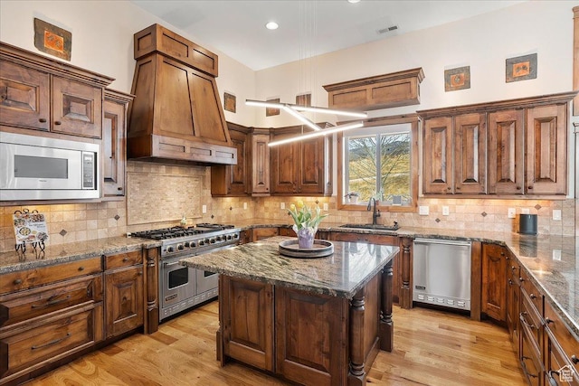 1049 S Meadow Lark Ln E, Huntsville, UT 84317 - kitchen with stainless steel appliances, a sink, stone counters, custom range hood, and recessed lighting