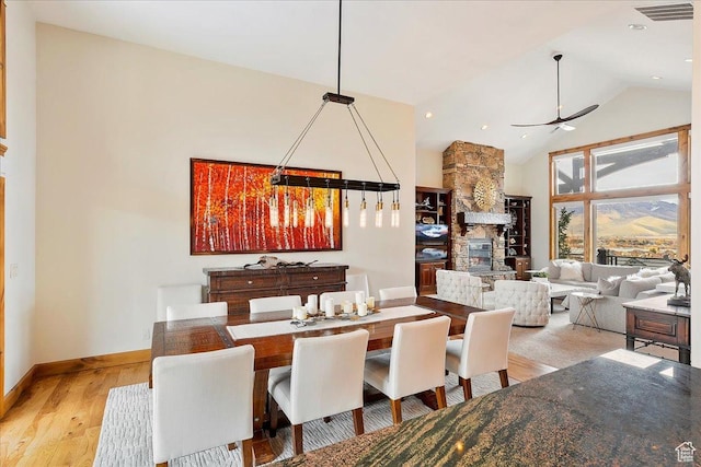 1049 S Meadow Lark Ln E, Huntsville, UT 84317 - dining room with a ceiling fan, high vaulted ceiling, light wood finished floors, baseboards, and a chandelier