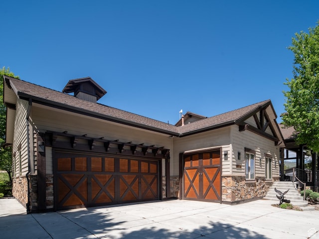 1049 S Meadow Lark Ln E, Huntsville, UT 84317 - view of side of home featuring stone siding, a garage, and concrete driveway