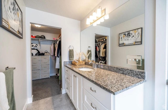 910 N 260 W, Santaquin, UT 84655 - full bath featuring tile patterned floors, a walk in closet, baseboards, and vanity