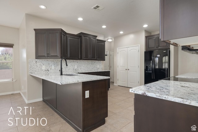 2445 E 2860 S, St George, UT 84790 - kitchen with black refrigerator with ice dispenser, backsplash, a sink, visible vents, and a peninsula