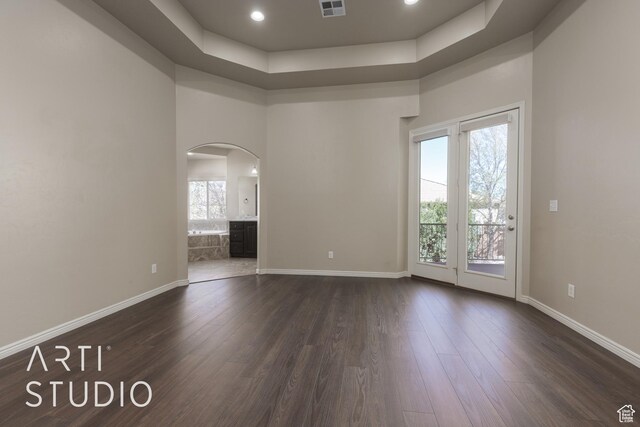 2445 E 2860 S, St George, UT 84790 - unfurnished room featuring arched walkways, dark wood-style floors, baseboards, and visible vents