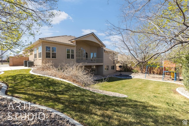 2445 E 2860 S, St George, UT 84790 - back of property with stucco siding, fence, a trampoline, a playground, and a lawn