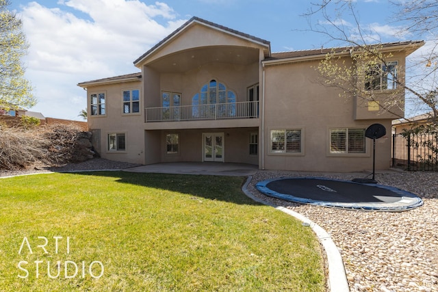 2445 E 2860 S, St George, UT 84790 - back of house featuring stucco siding, a trampoline, french doors, and a patio area