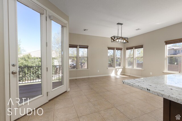 2445 E 2860 S, St George, UT 84790 - unfurnished dining area featuring light tile patterned floors, baseboards, and visible vents