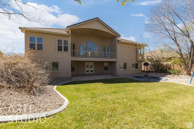 2445 E 2860 S, St George, UT 84790 - back of property with a balcony, a lawn, stucco siding, french doors, and a patio area