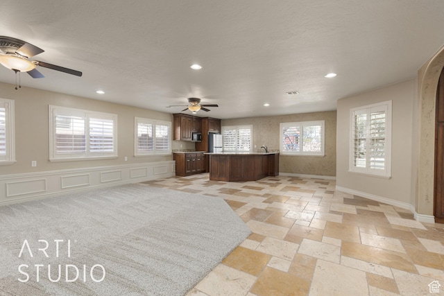 2445 E 2860 S, St George, UT 84790 - unfurnished living room featuring a ceiling fan, baseboards, a healthy amount of sunlight, and recessed lighting