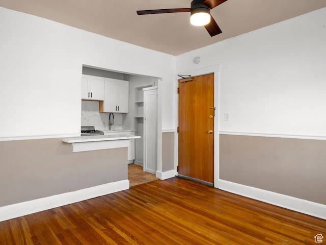 146 E 2nd Ave, Salt Lake City, UT 84103 - kitchen featuring decorative backsplash, light countertops, baseboards, ceiling fan, and wood finished floors