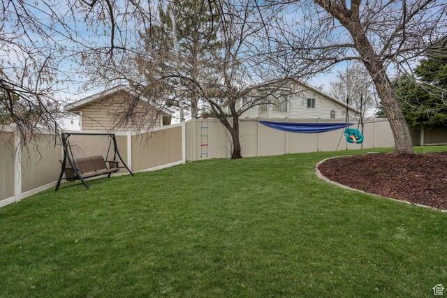 view of yard with a swimming pool and a fenced backyard