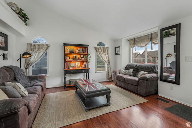 living room featuring baseboards, high vaulted ceiling, visible vents, and wood finished floors