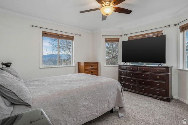 bedroom with carpet floors, crown molding, and multiple windows