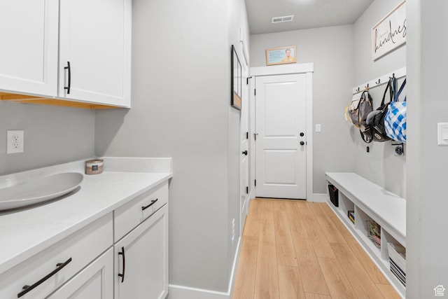 3161 N 3150 W, Plain City, UT 84404 - clothes washing area featuring baseboards, light wood-type flooring, and visible vents