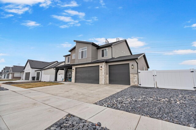 3161 N 3150 W, Plain City, UT 84404 - view of front facade featuring stone siding, a gate, fence, a garage, and driveway