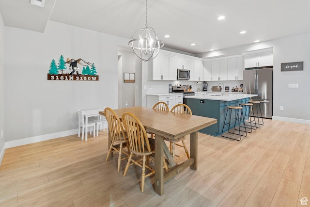 3161 N 3150 W, Plain City, UT 84404 - dining area featuring baseboards, light wood-type flooring, recessed lighting, and an inviting chandelier