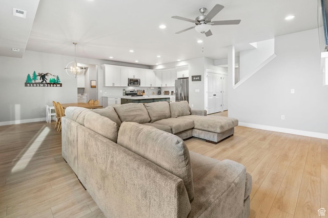 3161 N 3150 W, Plain City, UT 84404 - living area with recessed lighting, ceiling fan with notable chandelier, baseboards, visible vents, and light wood-style flooring