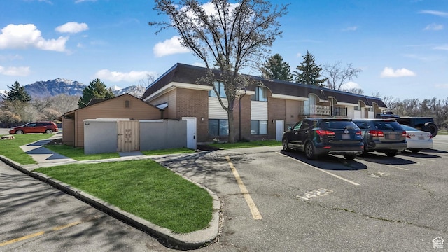 1423 Arthur Dr, Provo, UT 84601 - view of front of house with uncovered parking, a mountain view, and brick siding