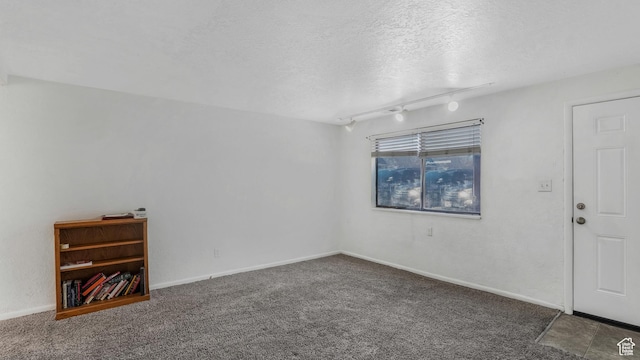 1423 Arthur Dr, Provo, UT 84601 - empty room featuring baseboards, rail lighting, carpet floors, and a textured ceiling