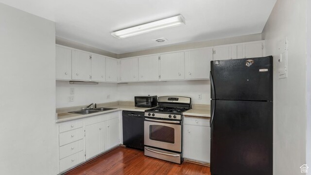 1423 Arthur Dr, Provo, UT 84601 - kitchen with white cabinetry, black appliances, light countertops, and a sink