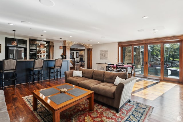 7507 Sage Meadow Rd, Park City, UT 84098 - living room featuring arched walkways, beverage cooler, wood finished floors, recessed lighting, and french doors