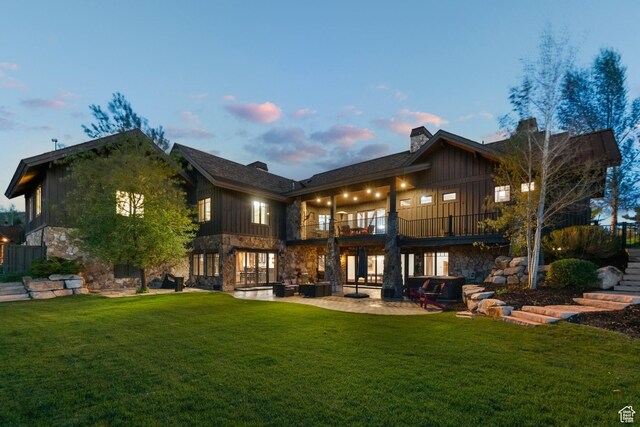 7507 Sage Meadow Rd, Park City, UT 84098 - back of house featuring a balcony, stone siding, and a yard