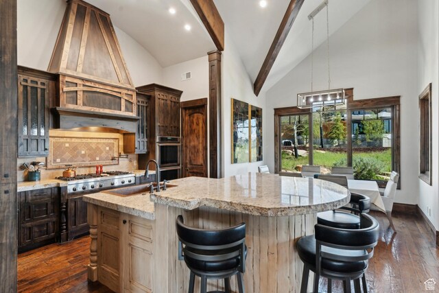 7507 Sage Meadow Rd, Park City, UT 84098 - kitchen featuring a sink, appliances with stainless steel finishes, decorative backsplash, beamed ceiling, and an island with sink