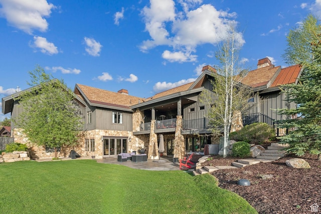 7507 Sage Meadow Rd, Park City, UT 84098 - back of house with a balcony, an outdoor living space, stone siding, a yard, and a patio area
