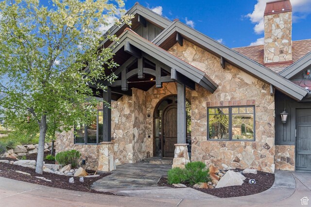 7507 Sage Meadow Rd, Park City, UT 84098 - entrance to property with stone siding, a chimney, and a shingled roof