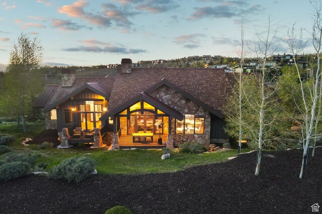 7507 Sage Meadow Rd, Park City, UT 84098 - back of house featuring stone siding and a chimney