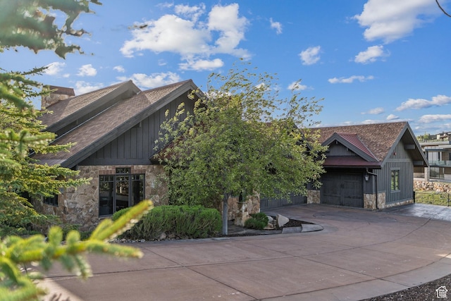7507 Sage Meadow Rd, Park City, UT 84098 - view of front of property featuring stone siding, board and batten siding, driveway, roof with shingles, and an attached garage