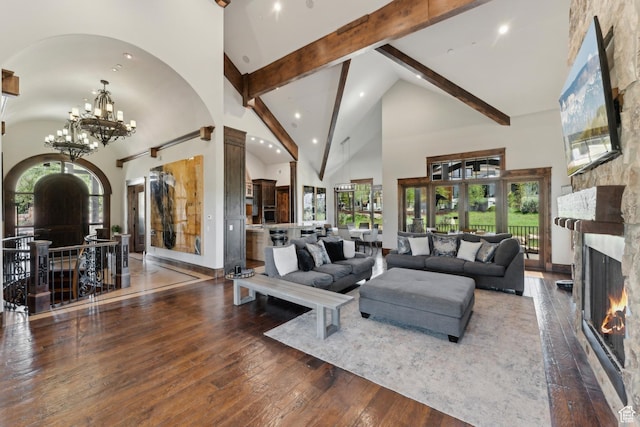7507 Sage Meadow Rd, Park City, UT 84098 - living room featuring high vaulted ceiling, a fireplace, beam ceiling, arched walkways, and hardwood / wood-style floors