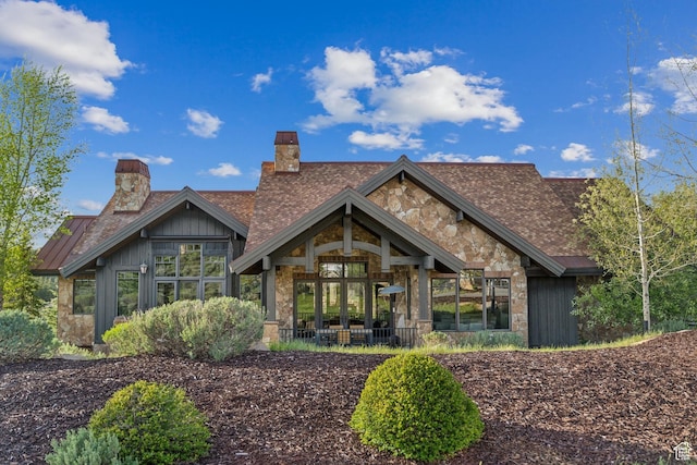 7507 Sage Meadow Rd, Park City, UT 84098 - rear view of house with a chimney, stone siding, and a standing seam roof
