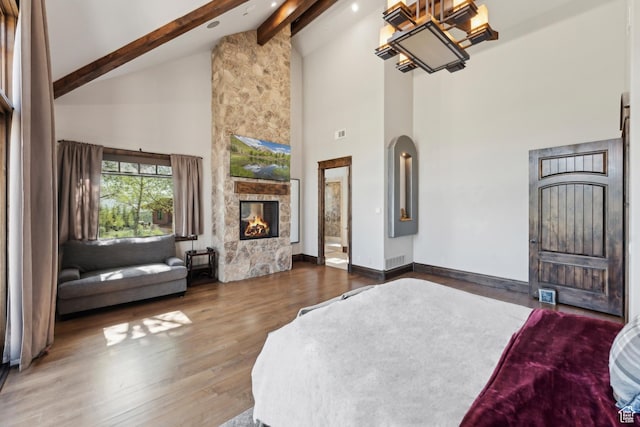 7507 Sage Meadow Rd, Park City, UT 84098 - bedroom with high vaulted ceiling, beamed ceiling, a stone fireplace, arched walkways, and wood finished floors