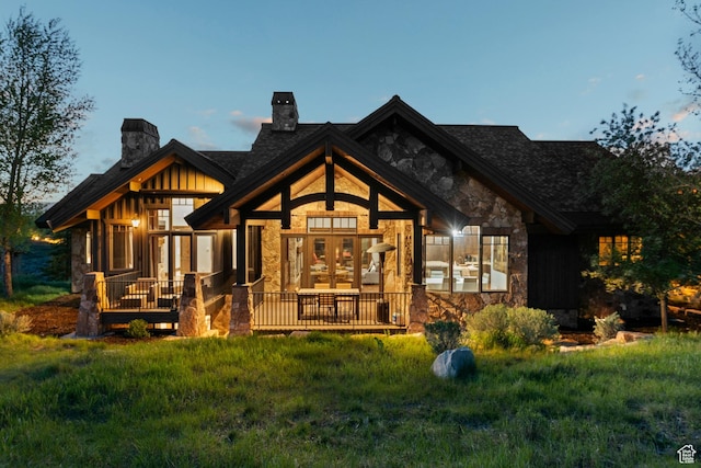 7507 Sage Meadow Rd, Park City, UT 84098 - rear view of property featuring a chimney, stone siding, a yard, and board and batten siding
