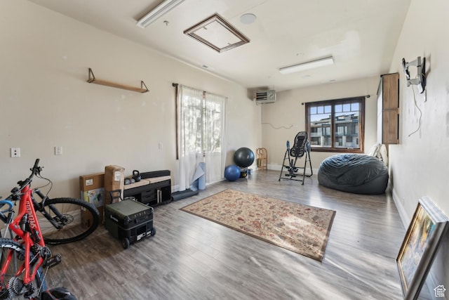 7507 Sage Meadow Rd, Park City, UT 84098 - exercise area with wood finished floors, a wall unit AC, attic access, and baseboards