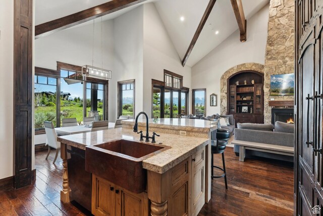 7507 Sage Meadow Rd, Park City, UT 84098 - kitchen featuring a sink, open floor plan, high vaulted ceiling, beam ceiling, and a fireplace