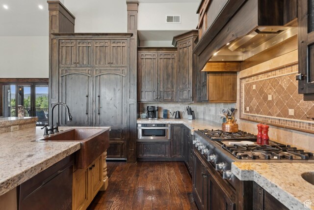 7507 Sage Meadow Rd, Park City, UT 84098 - kitchen with wall chimney exhaust hood, a sink, dark wood-style flooring, tasteful backsplash, and stainless steel gas cooktop