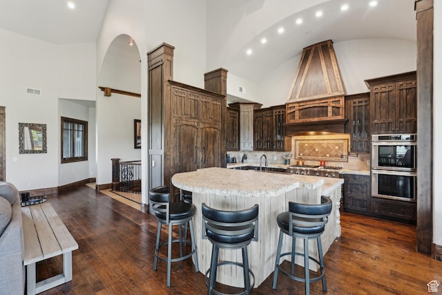 7507 Sage Meadow Rd, Park City, UT 84098 - kitchen featuring stainless steel appliances, high vaulted ceiling, recessed lighting, dark wood-style floors, and a center island with sink