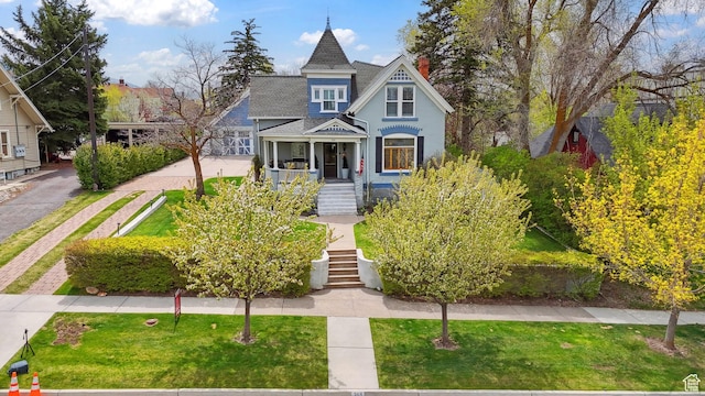 368 E 300 N, Logan, UT 84321 - victorian home featuring stairway, stucco siding, a front yard, and roof with shingles
