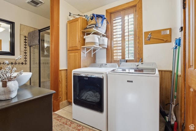 368 E 300 N, Logan, UT 84321 - laundry area featuring independent washer and dryer, cabinet space, a wainscoted wall, visible vents, and light tile patterned flooring