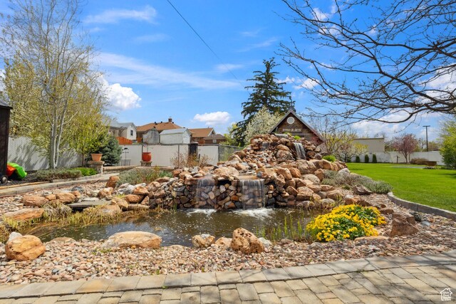 368 E 300 N, Logan, UT 84321 - community / neighborhood sign with fence, a yard, a small pond, and a residential view
